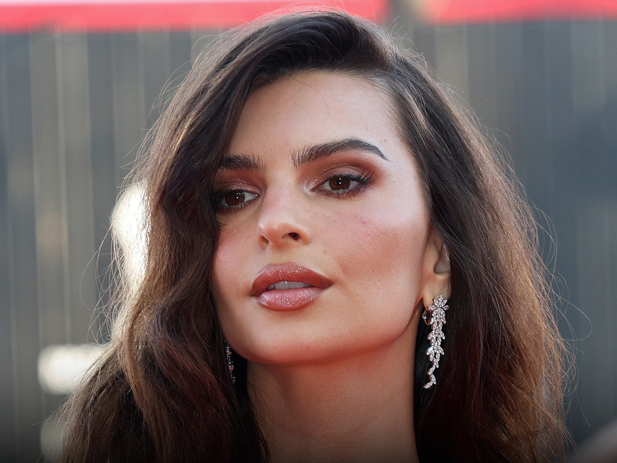 Emily Ratajkowski in plunging red one-piece swimsuit at Beverly Hills Hotel pool, March 2026