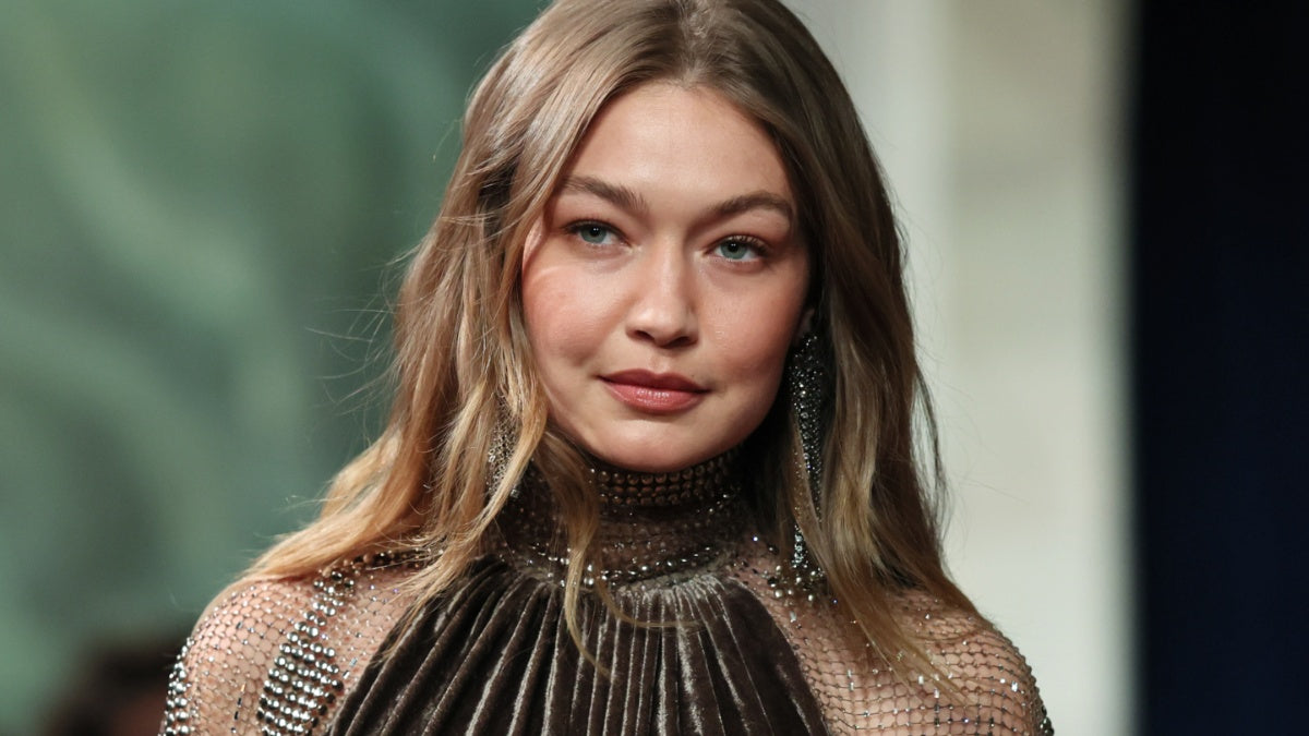 Gigi Hadid in blue string bikini top for Guest in Residence Spring 2026 campaign