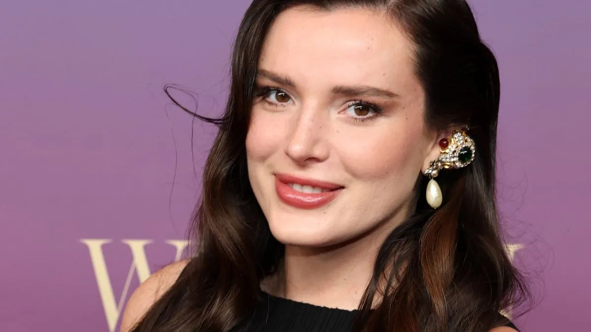 Bella Thorne in black bikini-style top with white trim, February 2026