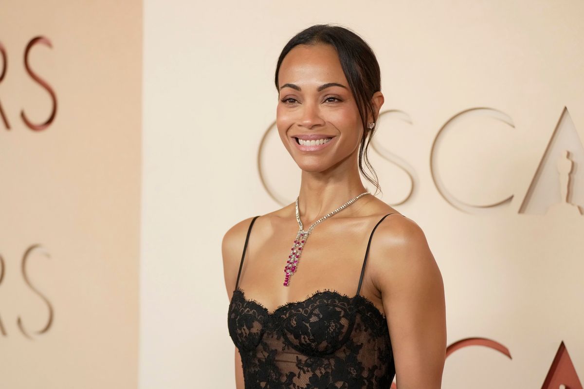 Zoe Saldaña in Saint Laurent black lace gown at the 2026 Oscars ceremony