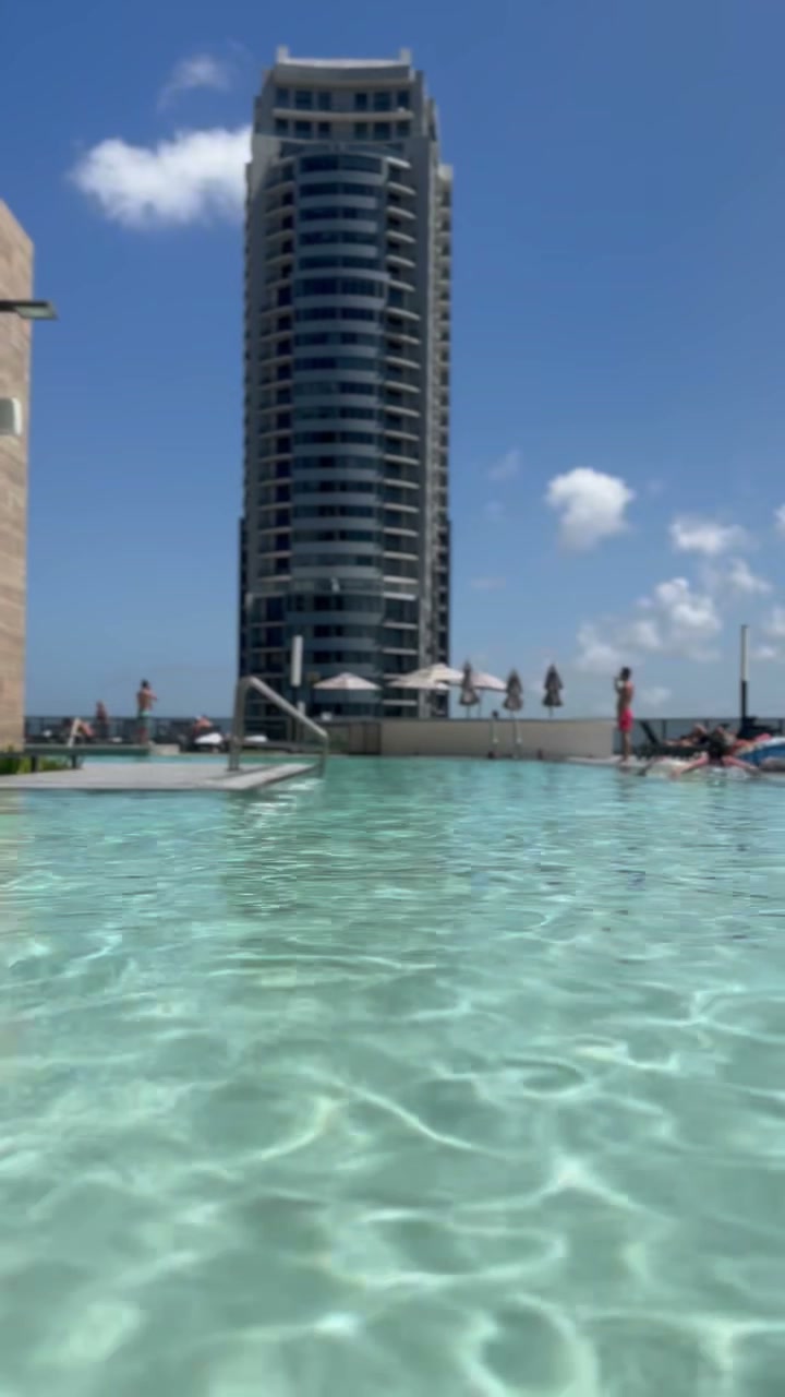 Luxury infinity pool with turquoise water and resort backdrop — Mykonos 2026 bikini guide by Audi Swim