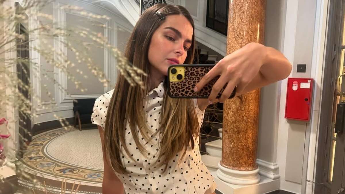 Addison Rae lying on the beach in a light pink bikini in Perth Australia