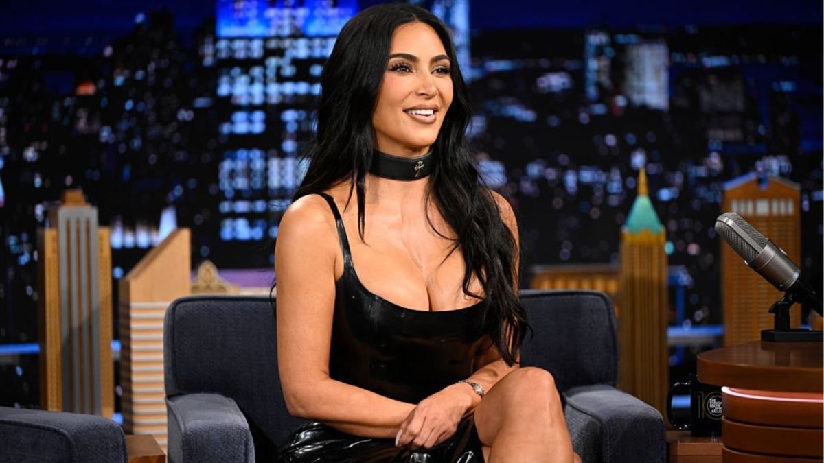 Kim Kardashian in a black SKIMS triangle bikini for a 2026 campaign