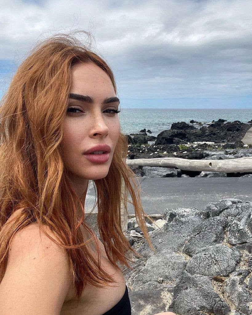 Megan Fox with auburn hair near the water in spring 2026